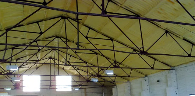 Large commercial building interior with exposed roof structure